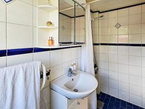a bathroom with a sink and a mirror at 4 star holiday home in TJÖRN in Almösund +35 photos