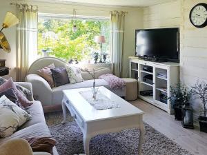 a living room with a couch and a tv at 4 star holiday home in TJÖRN in Almösund
