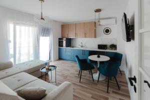 a living room with a couch and a table at Atelier 51 - Free parking in Mostar