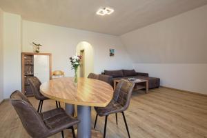 a living room with a table and chairs and a couch at Gemütliche FeWo in Dinkelsbühl in Dinkelsbühl