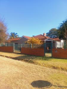 a fence with a gate in front of a house at The Rehoboth in Dundee +7 photos