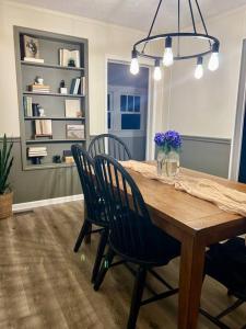a dining room with a wooden table and chairs at Quaint City Cottage Bremen, Ga in Bremen