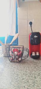 a basket of cups and a toaster on a counter at Zoes House in Kyra Panagia