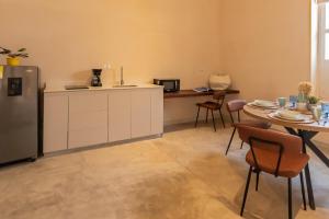 a kitchen with a refrigerator and a table with chairs at Nueva Apartasuite pleno centro in Santa Marta