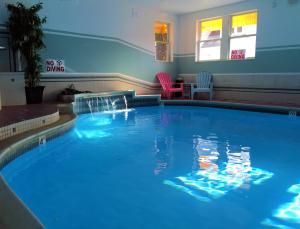 a large blue swimming pool in a hotel room at Camden Riverhouse Hotel and Inn in Camden