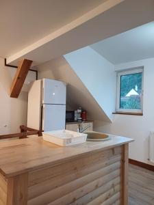 a kitchen with a white refrigerator on a wooden counter at Cazare Rasnov in Râşnov