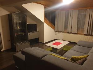 a living room with a couch and a table at Weisses Rössel-Cavallo Bianco in Werfen