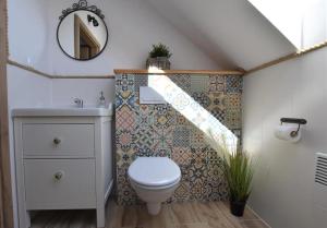 a bathroom with a toilet and a sink at Domek na Kaszubach 26-2 - Ostoja Bukowo in Borowy Młyn