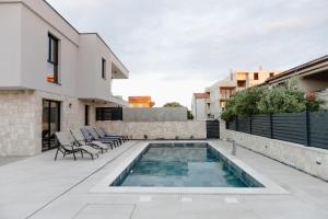 a swimming pool on the roof of a house at Luxury Villa Pam - Private villa with a heated pool and a summer terace with 4 bedrooms - 230 m2 NEW!! in Mandre