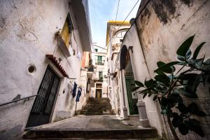 an alleyway in an old town with stairs at Amalfi Luxury House in Amalfi
