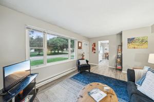 a living room with a tv and a couch at Daffodil House - Large 6 Bedroom Accessible Rental in Stillwater