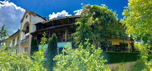 a building with trees in front of it at Casanova Inn - Boutique Hotel in Dilijan