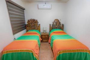 a room with two beds in a room at Casita Luna Sol in La Paz +1 photo