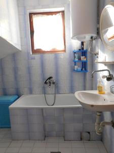 a bathroom with a shower and a tub and a sink at Apartmani Ceca Blaznava in Topola +20 photos