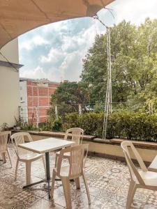 a patio with a table and chairs on a roof at Suites Hamburgo in Mexico City +32 photos