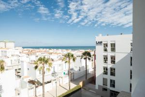 a view from the balcony of a building with palm trees at LAN Suites Antilla Playa in La Antilla