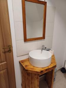 a bathroom with a white sink and a mirror at Cazare Rasnov in Râşnov