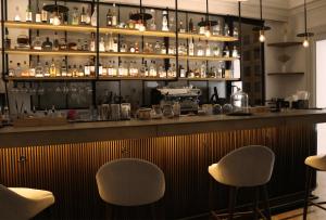 a bar with two chairs in front of a counter at Il Buongustaio in San Salvador