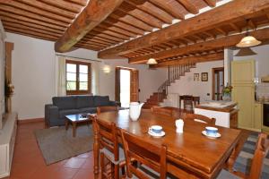 a living room with a table and a couch at Casa Sofi - Happy Rentals in Monticiano