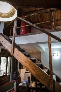 a spiral staircase in a room with wooden ceilings at Finca La Colorada in San Salvador de Jujuy