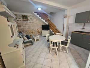 a kitchen and living room with a table and chairs at Apartment Melita in Murter