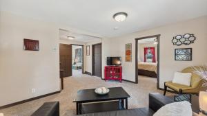 a living room with a couch and a tv at Red Hibiscus House - 3 Blocks from Lake Pepin in Lake City
