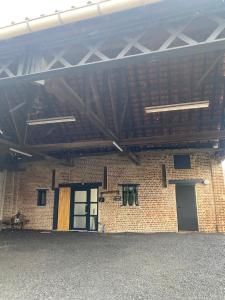 a brick building with two windows and a roof at GE Appart Lille Douai Valenciennes à 20 min et à 3 mn orchies gare Lille Orchies parking terrasse in Coutiches
