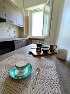 a table with a cup and a plate and a spoon at verdazzurro lago in Abbadia Lariana