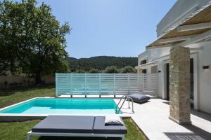 a swimming pool in the backyard of a house at Astrum Luxury Suites in Vourvourou