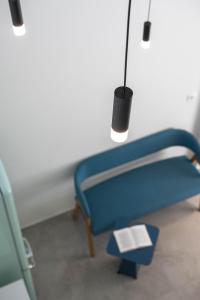 a blue bench with a lamp and a book at Astrum Luxury Suites in Vourvourou