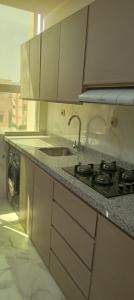 a kitchen with a sink and a counter top at Nador al jadid chaabi in Nador