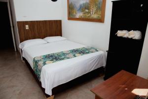 Letto o letti in una camera di Hotel Portal Guatapé