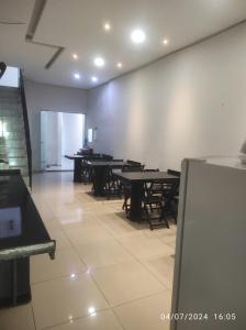 an empty room with tables and chairs in it at Pousada central Russana in Russas