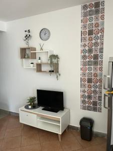 a living room with a tv on a white wall at Apartment Nona in Cres