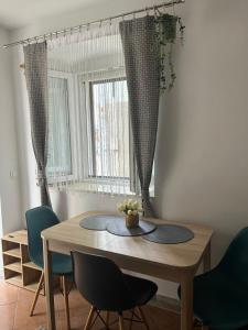 a dining room with a wooden table and chairs at Apartment Nona in Cres