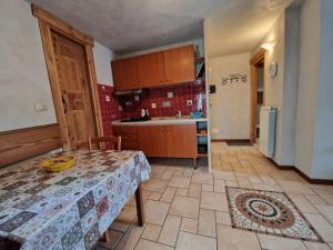 a kitchen with a table and a kitchen with a sink at Apartament in the CENTER in Sauze dʼOulx