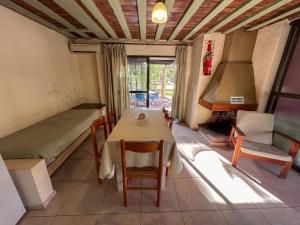 a room with a table and a bed and a fireplace at Cabañas Del Sol in Valle Grande