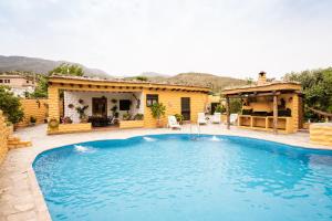 a swimming pool in front of a house at Casas Amaro in Órgiva