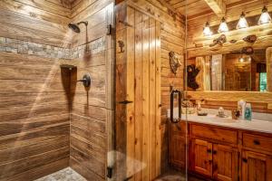 a bathroom with a shower and a sink at Miss BeeHaven in Sevierville +37 photos
