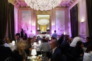 a group of people sitting at tables in a room at Hotel C2 in Marseille