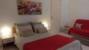 a bedroom with a bed with a red blanket at Great apartment Katarina in Zadar