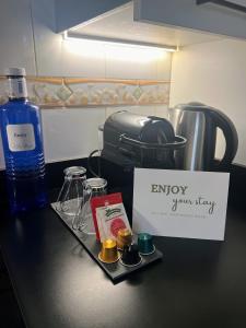 a black counter with a sign and a bottle of water at Sol y Mar Villajoyosa in Villajoyosa