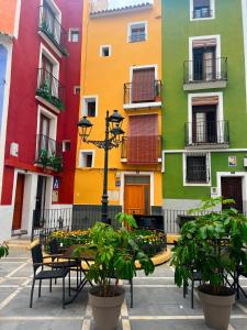 a courtyard with tables and chairs in front of buildings at Sol y Mar Villajoyosa in Villajoyosa