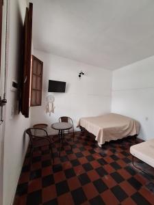 a room with a bed and a table and chairs at Casa Alba in San Salvador de Jujuy +9 photos