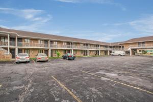 a large building with cars parked in a parking lot at Motel 6-Windsor, ON in Windsor +18 photos