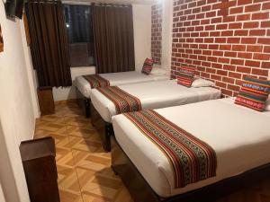 Postel nebo postele na pokoji v ubytování Quipu Hostal