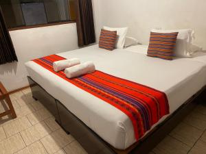 Llit o llits en una habitació de Quipu Hostal