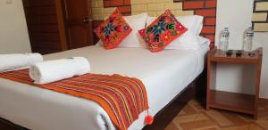 Postel nebo postele na pokoji v ubytování Quipu Hostal + 6 fotografií