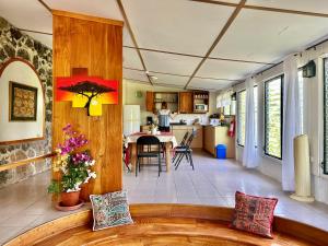 a living room with a couch and a kitchen at Jean's Home in Puerto Ayora
