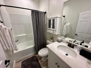 a bathroom with a sink and a toilet and a shower at Cape Coral-Ft Myers Waterfront Four Bedroom Home in Cape Coral +12 photos